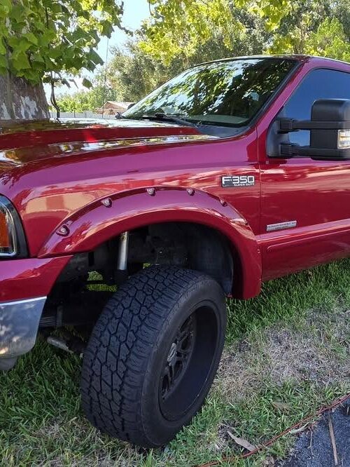 Red Ford Super Duty with glossy paint after a foam wash