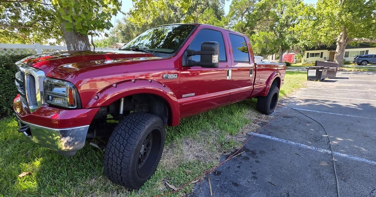 Red lifted Ford Super Duty, washed and shining in the sun