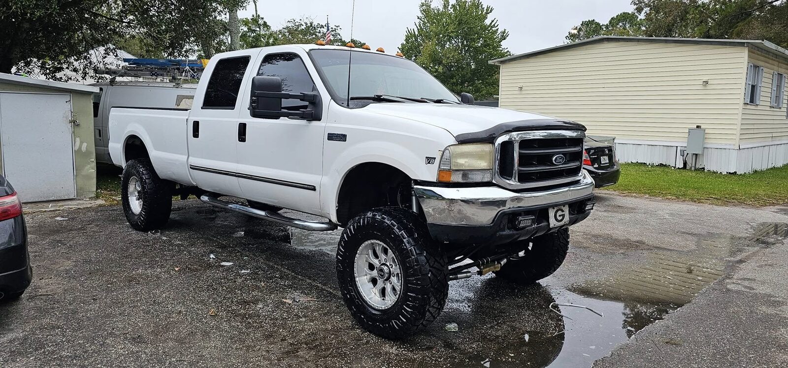 White lifted Ford F-350 after a foam wash