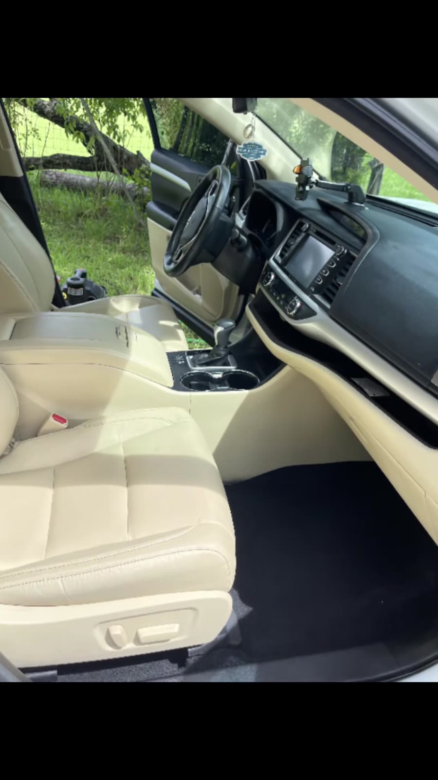 Clean tan leather seats and carpet in an SUV