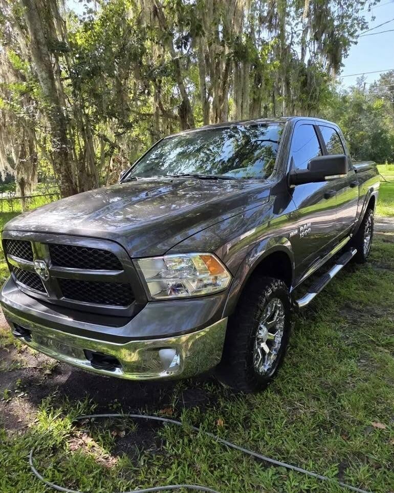 Grey Ram 1500 freshly detailed under oak trees