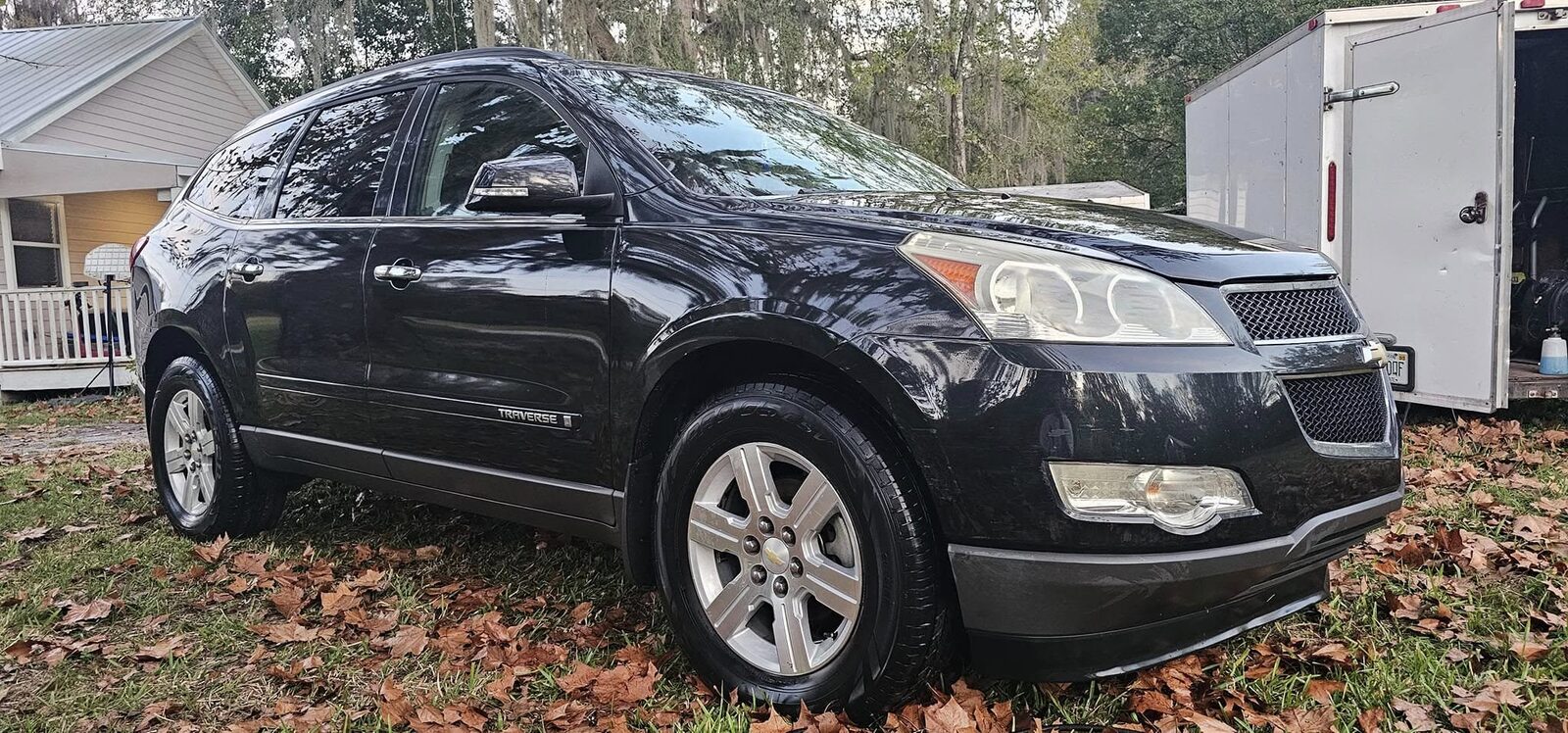 Black Chevrolet Traverse, freshly washed and still wet