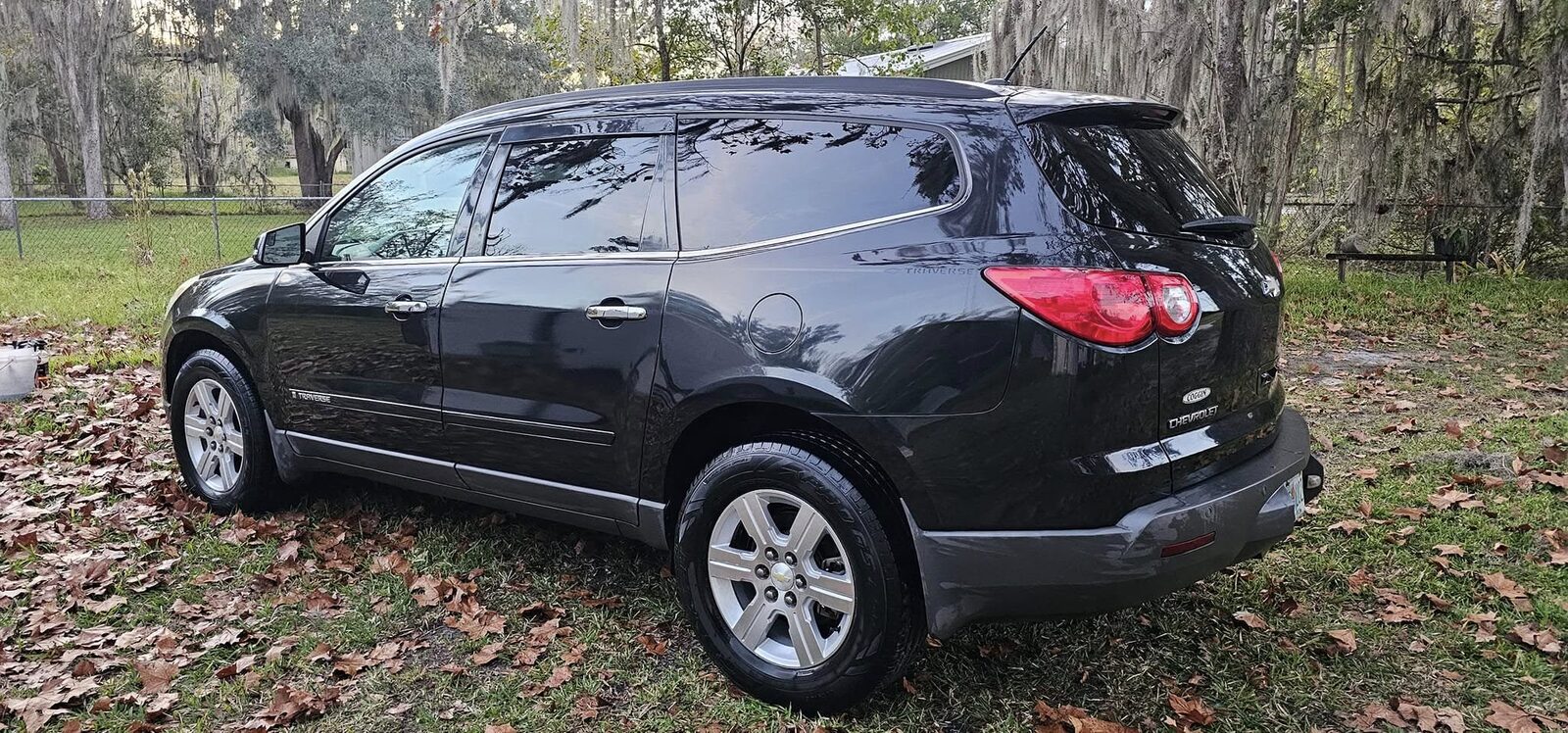 Rear of a black Chevrolet Traverse after a wash